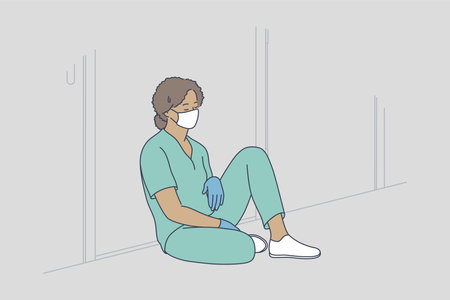 Doctor burnout, stress, hard conditions during pandemic concept. Tired exhausted black female nurse or doctor wearing protective face mask, gloves and blue uniform sitting on hospital floorのイラスト素材
