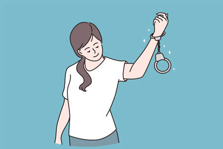Freedom and release concept. Young positive girl cartoon character standing and looking at handcuffs an her hand feeling cute and confident to release vector illustrationのイラスト素材