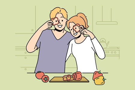Smiling couple cooking food at kitchenのイラスト素材