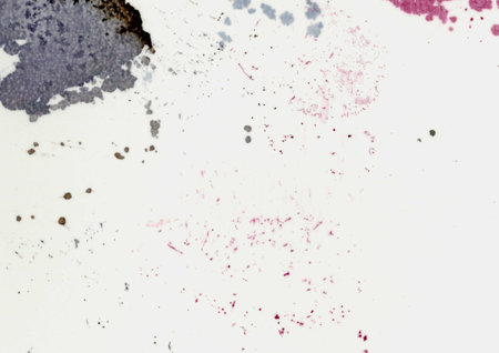 Large image close up of paper texture background scan with large colorful ink pink, purple, black, brown color stains, spots, dots and blotches wallpaper with copy space for text dirty used paperの写真素材