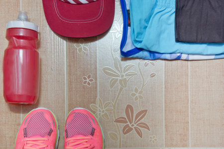 Running stuff laid out ready for a race day. Soft focus. Brown background.の写真素材