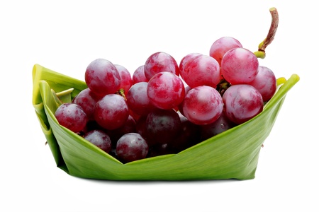 Red grapes on green boat の写真素材