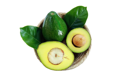 The basket of fresh avocado fruits on white background.の写真素材
