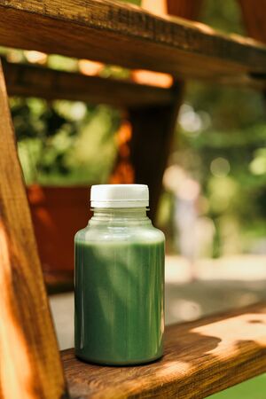 Mango smoothie in a glass Mason jar and mango on a green background. shake. Tropical fruit concept.の写真素材