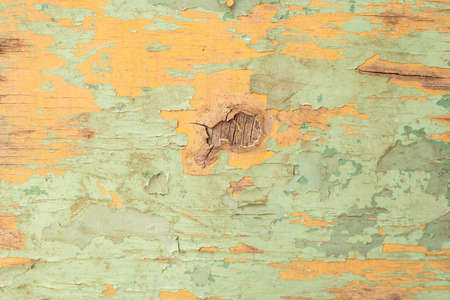 wood wall with cracked light green paint, through the paint. background, textureの写真素材