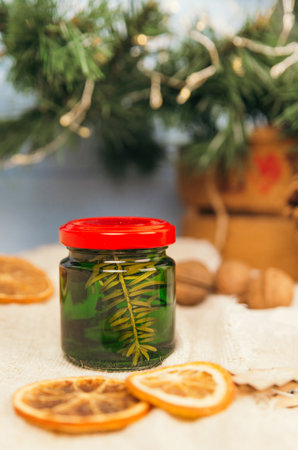 Jar with honey tincture of forest pine needles. Means and medicines of folk medicine.の写真素材