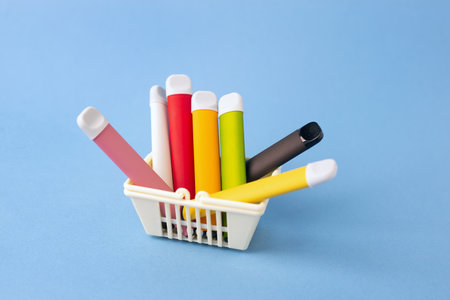 A set of multi-colored sticks - disposable vaping devices, electronic cigarettes in a shopping...