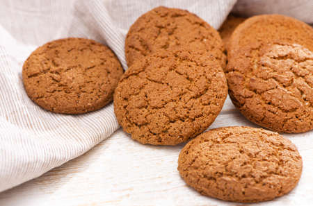 Freshly baked oatmeal cookies on rustic wood background. Close Up from above with natural...