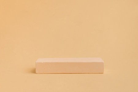Concrete stage of rectangular shape on beige background. Empty showcase for product presentation....