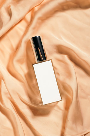 perfume bottle on a silk beige background with mock-up. beauty and fragrance conceptの写真素材