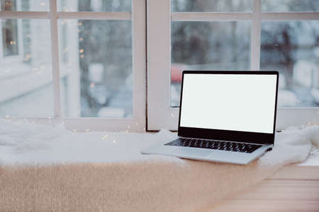 Laptop with place for text on windowsill. Telework. freelance. Computer with copy space on warm...