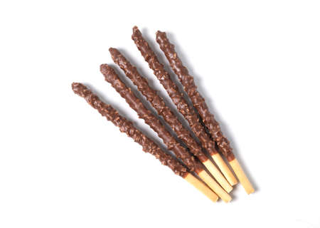 Chocolate mixed biscuit stick isolated on white background. crispy sweet straws filled chocolate with crushed nuts. top view.の写真素材