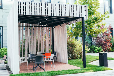 Modern smoking zone outside. business building, wooden gazebo with chairs. green zone. modern...
