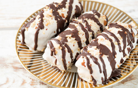 butter cookies dessert covered in chocolate and walnut glaze on gray table.