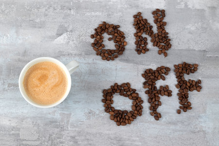 cup of coffee as a switch between ON and OFF beans, gray stone background, morning or waking up conceptの写真素材