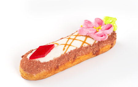 Traditional glazed French dessert with original cream decoration on a white background.