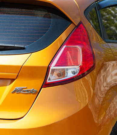 Ukraine, Kyiv, April 10, 2024. Yellow Ford Focus is parked on the street of the city. View of the rear lights of the car. rear lightのeditorial素材