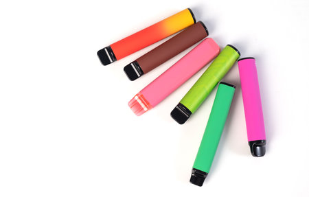 A set of colorful disposable electronic cigarettes of different shapes on a white background. modern...