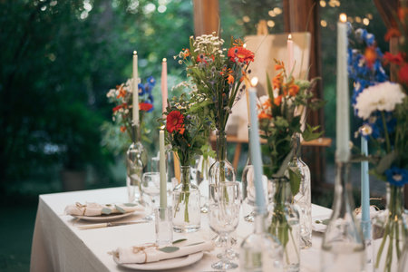 Decorated atmospheric table for a conservatory wedding. The concept of serving and decorating the holidayの写真素材