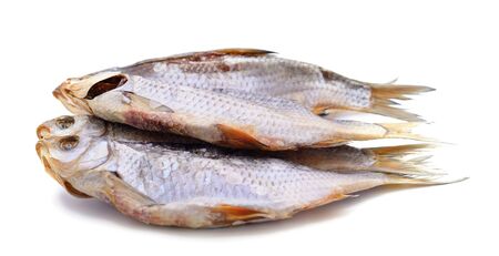 Two dried fish isolated on a white background.の写真素材