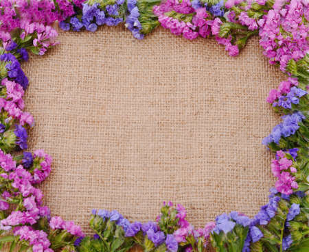 Static multicolored flowers on burlap.の写真素材