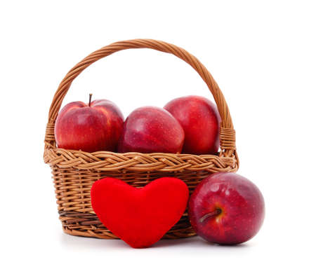 Apples in the basket with heart isolated on a white background.の写真素材