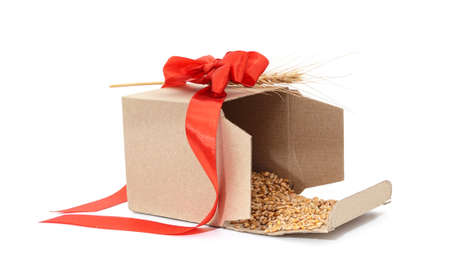 Grain in a box with spikelets isolated on a white background.の写真素材