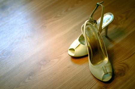 Women's high heels on the wood floorの写真素材