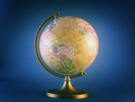 little antique globe isolated on blue backgroundの写真素材