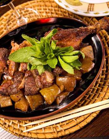 Delicious roasted duck with potatoes and mintの写真素材