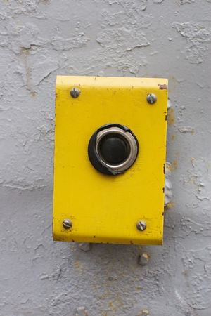 control button on yellow metal plate