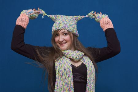 Portrait of a young surprised girl in winter hat