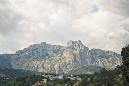 Mountain landscape with clouds and green treesの写真素材