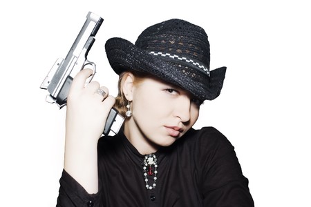 Western girl in black with a gun isolated on whiteの写真素材