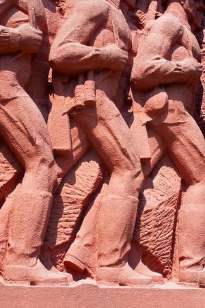 WWII military monument with marching Soviet soldiers in army boots in Chisinau memorial complex