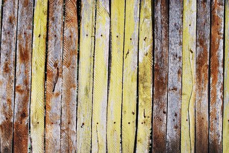 Grungy old wooden picket fence texture with peeled paintの写真素材