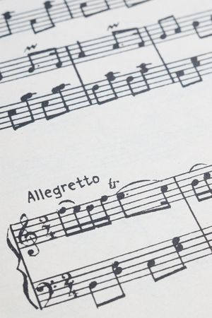 Closeup of music notes sheet with selective focus on allegretto text