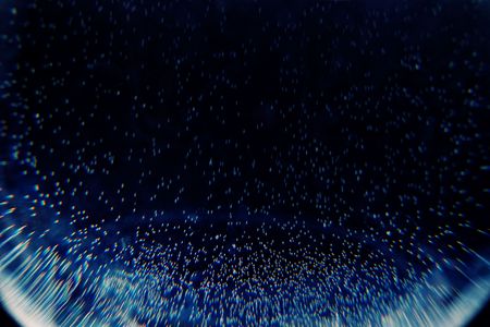 Abstract air bubbles in water with colored diffraction and motion blur in the darkの写真素材