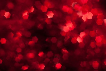 blurred red star shape lights on black backgroundの写真素材