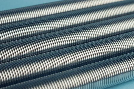 Five metal coil springs on blue background with selective focusの写真素材