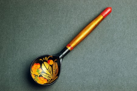 Russian national artistic wooden spoon on black paper texture の写真素材