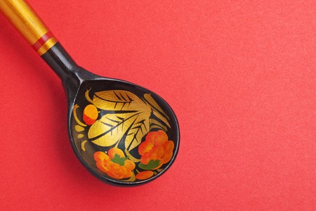 Russian national artistic wooden spoon on red paper texture の写真素材