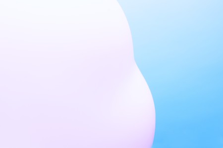 Abstract blurred pink shape against blue backgroundの写真素材