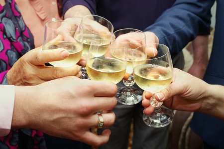 Closeup of many hands making toast with champagne with selective focusの写真素材