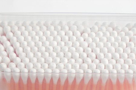 Rows of heads of cotton swabs inside the box with selective focus