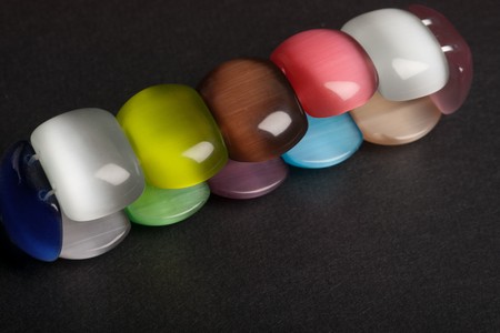 Cats eye quartz bracelet on black textured background with selective focusの写真素材