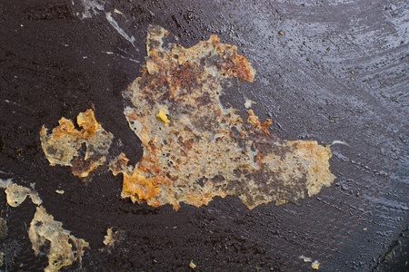 Closeup of surface of frying pan with scorched food stainの写真素材