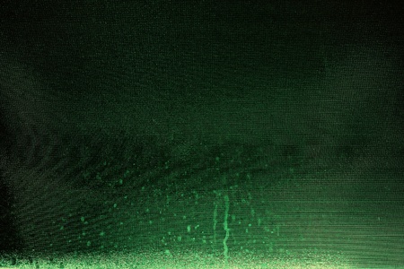 Dark green meshed background with stains and light falloffの写真素材
