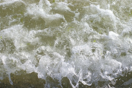 Closeup of breaking sea wave splash on the beach with selective focus 
