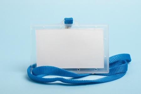 Closeup of wrapped orange lollipop on a stick against blue background の写真素材